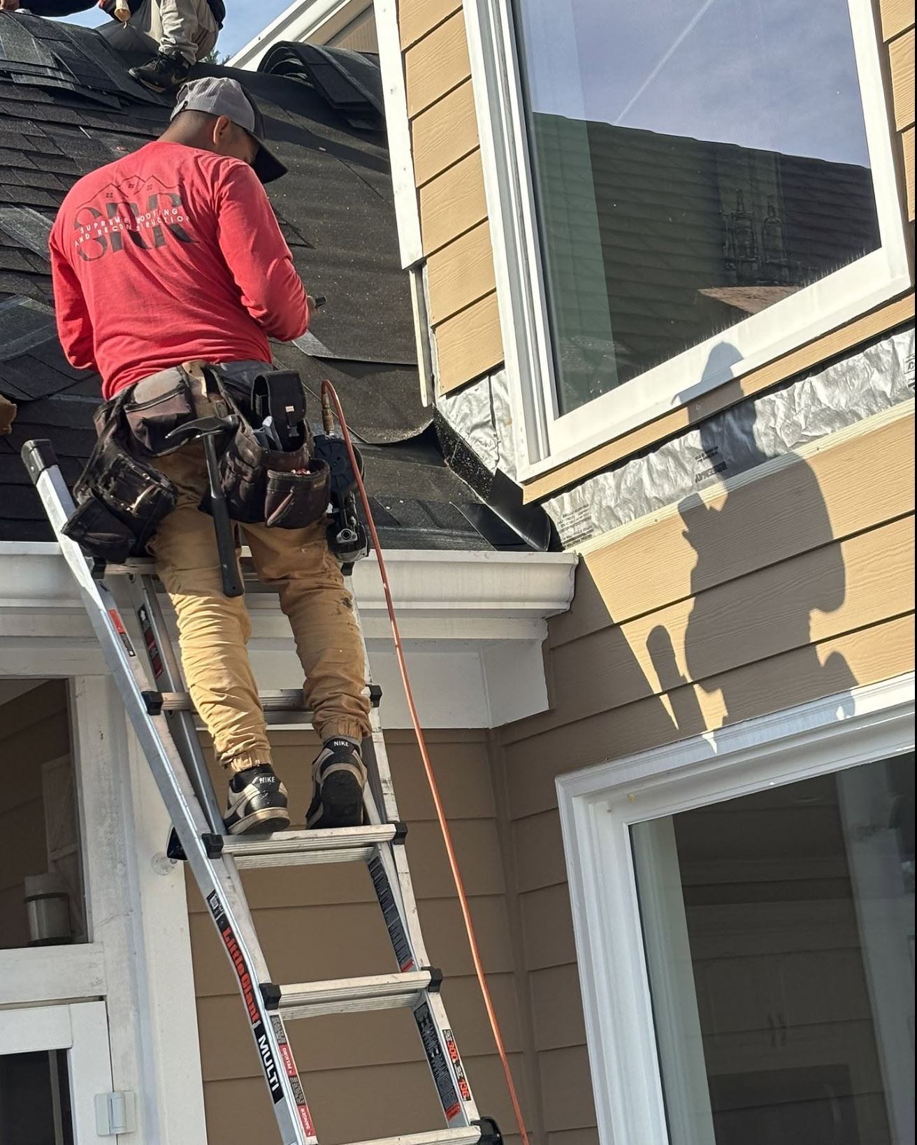 Supreme Roofing crew installing gutters in Johns Creek, Fulton County GA